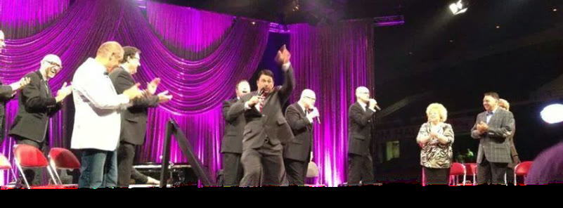 Brian Burchfield singing on stage with other gospel artists
